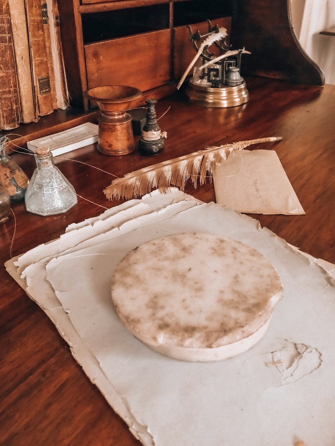 Antique desk with vintage writing tools and old papers.