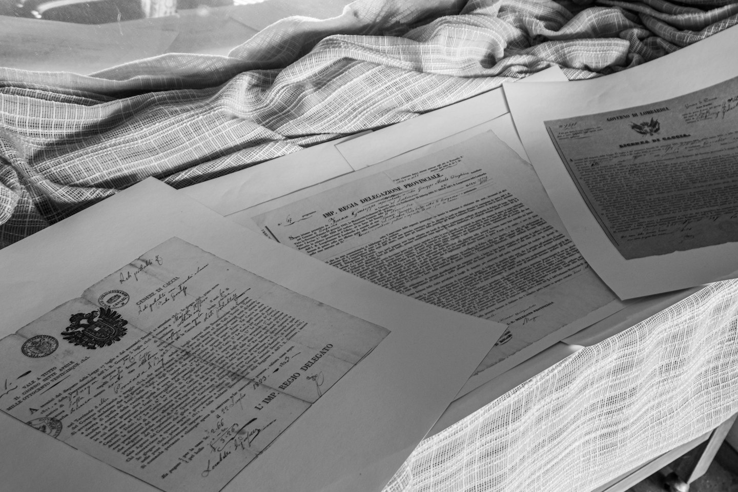 Old official documents spread on fabric.